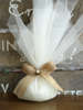 Γαμήλια μπομπονιέρα από εκρού γαλλική οργάντζα, με φιόγκο από κορδέλα γιούτα και πέρλα.