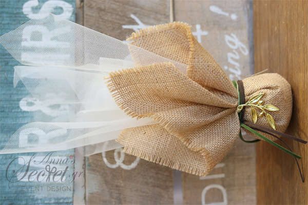 Μπομπονιέρα γάμου με οργάντζα και λινάτσα σε φυσικό χρώμα, μεταλλικό κλαδί ελιάς και διπλό κορδόνι σουετ